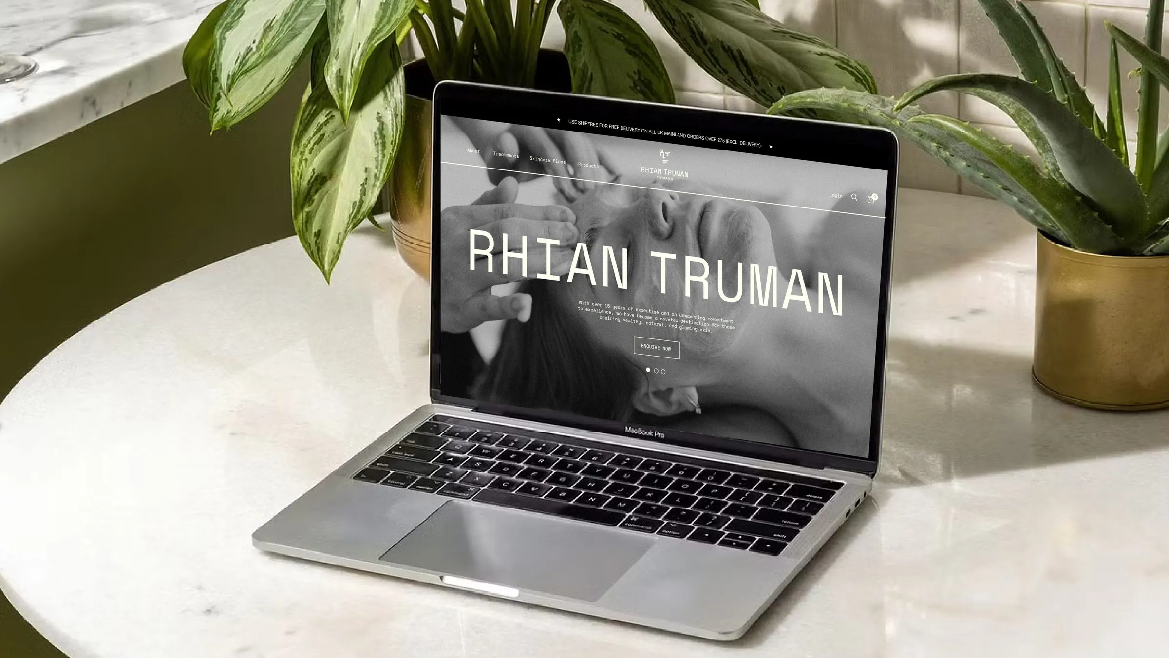The Rhian Truman Therapies website on a laptop on a marble table