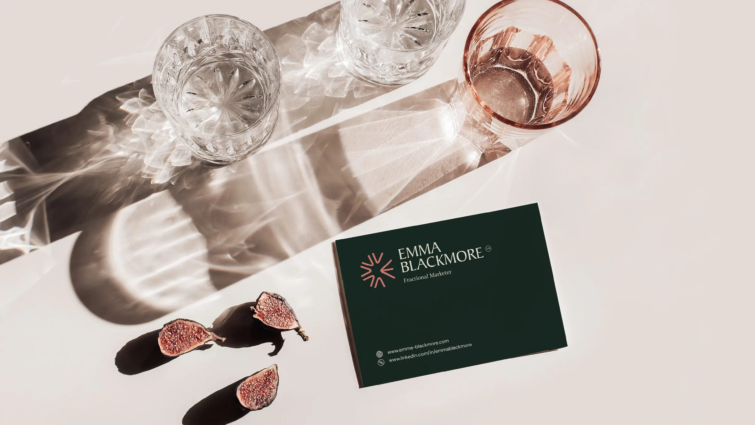 Emma Blackmore business cards on a table with glasses and figs