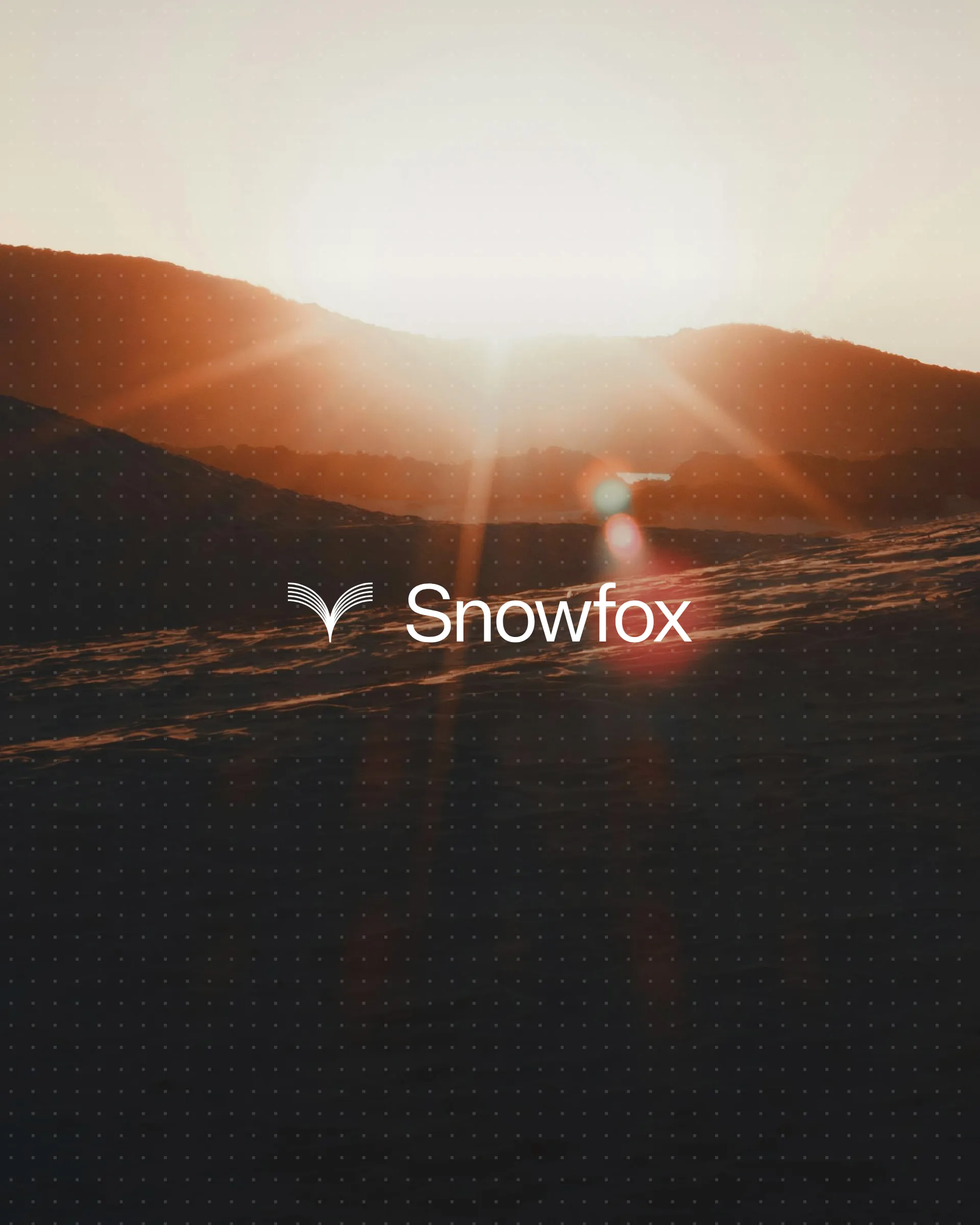 The Snowfox logo over a sunrise across snowy hills